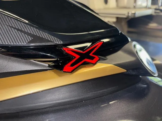 Slide: The Image of 2019 Sea-Doo RXTX close-up with red "X" emblem on sleek black and gold design. - 18