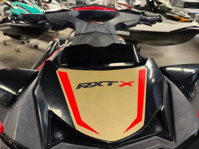 Slide: The Image of 2019 Sea-Doo RXTX jet ski, black and red design, displayed in a showroom. - 19