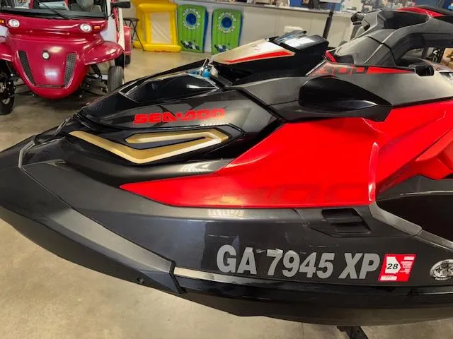 Slide: The Image of 2019 Sea-Doo RXTX jet ski in showroom, black and red design, registration GA 7945 XP. - 5