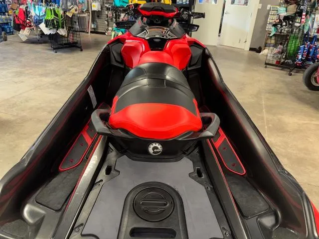 Slide: The Image of 2019 Sea-Doo RXTX jet ski with red and black seating, displayed indoors. - 9