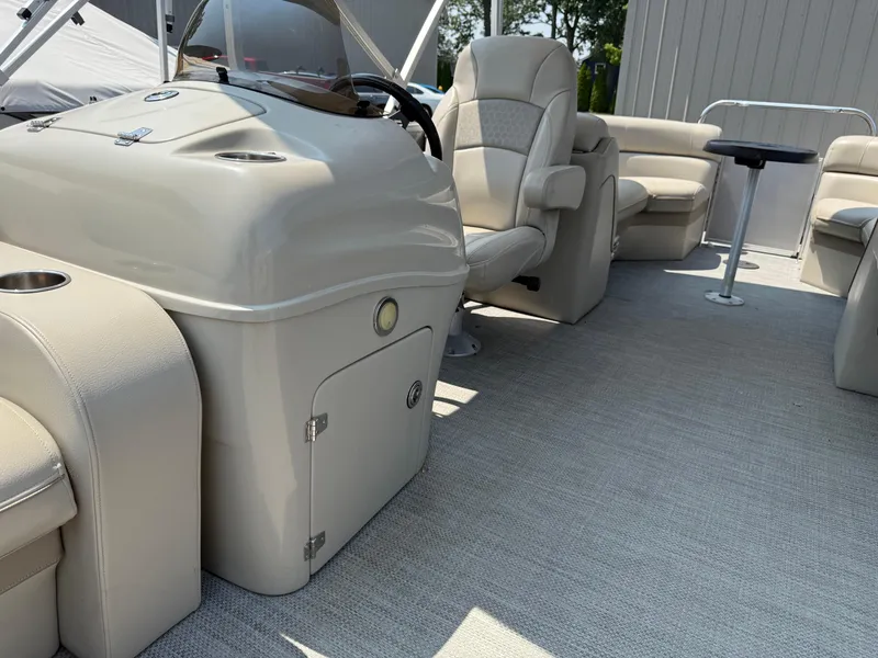 Slide: The Image of 2016 South Bay 521RS pontoon boat interior with beige seating and helm. - 12