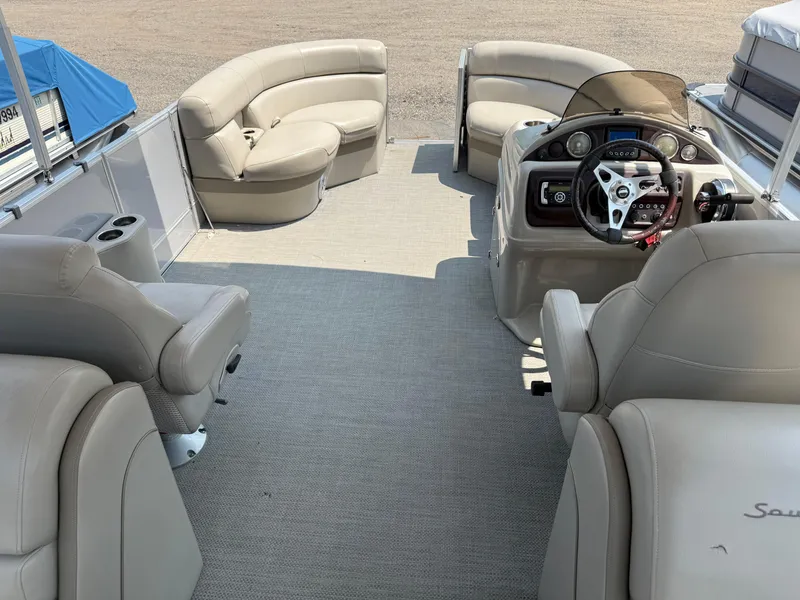 Slide: The Image of 2016 South Bay 521RS pontoon boat interior with beige seating and steering console. - 15