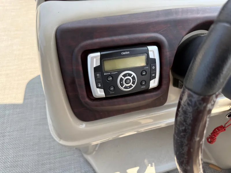 Slide: The Image of Clarion audio system on 2016 South Bay 521RS boat dashboard. - 17