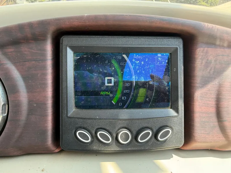 Slide: The Image of Dashboard display of a 2016 South Bay 521RS boat showing RPM and fuel levels. - 18