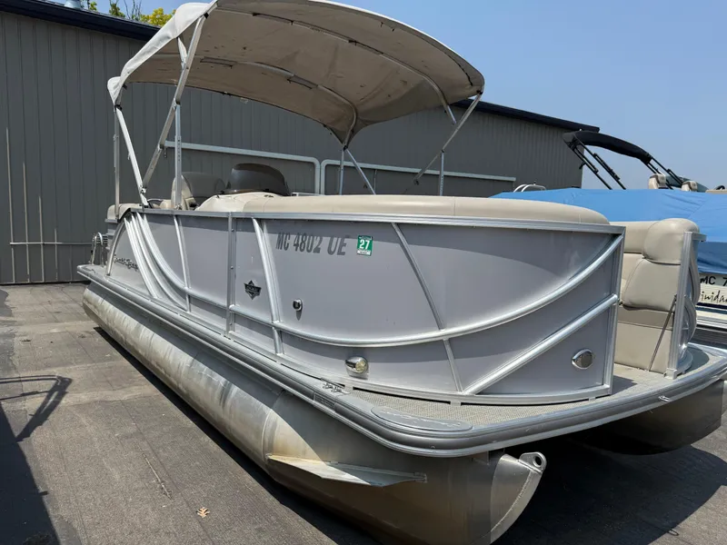 Slide: The Image of 2016 South Bay 521RS pontoon boat with canopy, parked outdoors. - 2