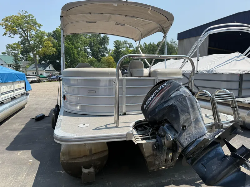 Slide: The Image of 2016 South Bay 521RS pontoon boat with Mercury outboard motor, parked outdoors. - 5