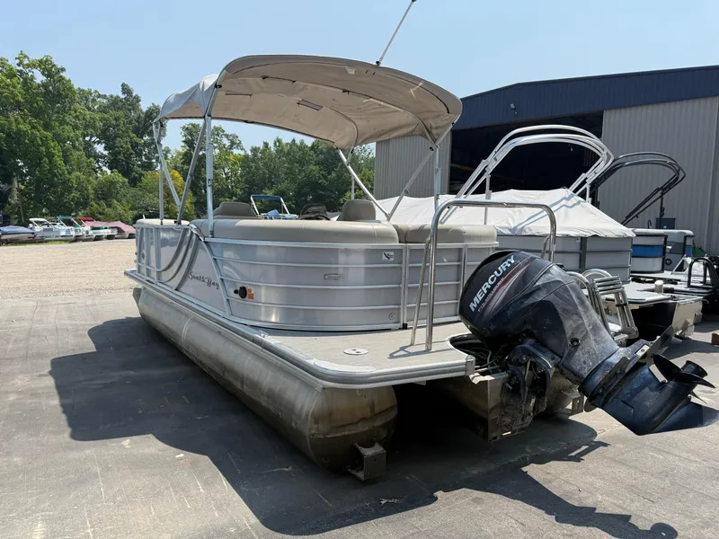 Slide: The Image of 2016 South Bay 521RS pontoon boat with Mercury outboard motor, parked outdoors. - 6