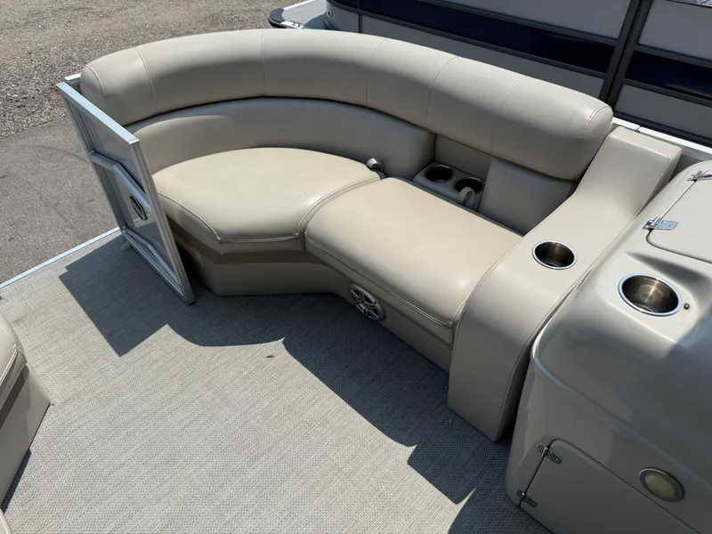 Slide: The Image of 2016 South Bay 521RS boat interior with beige seating and cup holders. - 8