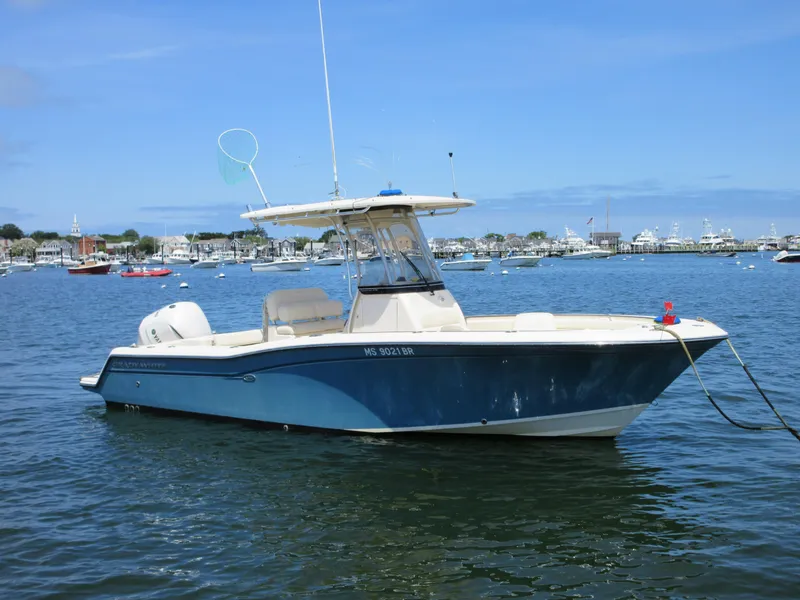 Slide: The Image of 2019 Grady-White Fisherman 236 boat on calm water, with marina in background. - 0