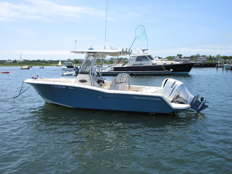 Slide: The Image of 2019 Grady-White Fisherman 236 boat on water, clear sky, other boats in background. - 1