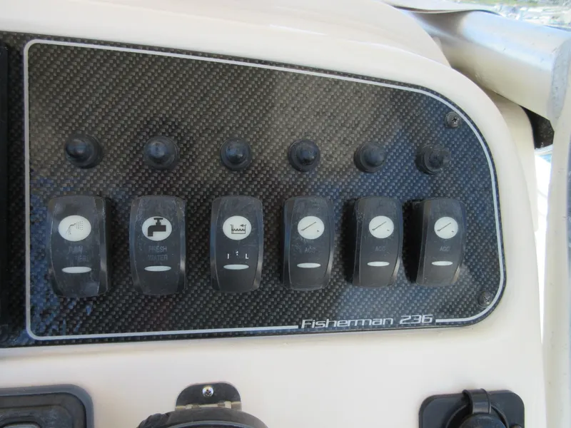 Slide: The Image of Control panel of 2019 Grady-White Fisherman 236 boat with labeled switches. - 15