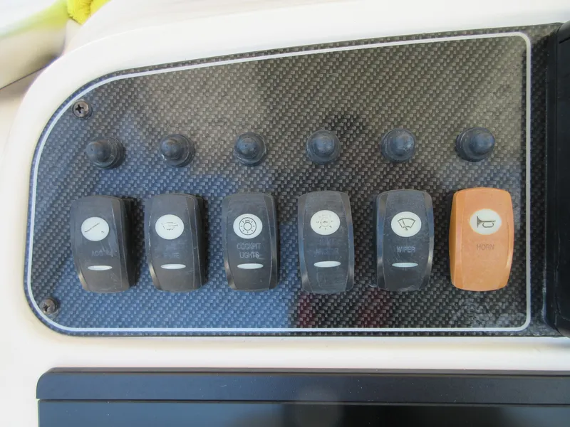 Slide: The Image of Control panel of a 2019 Grady-White Fisherman 236 boat with labeled switches. - 17