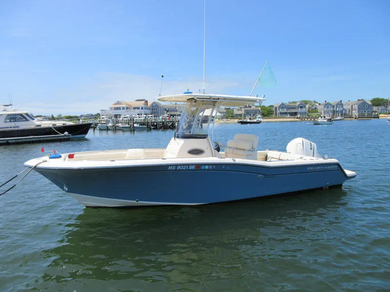Slide: The Image of 2019 Grady-White Fisherman 236 boat docked in a scenic harbor. - 2