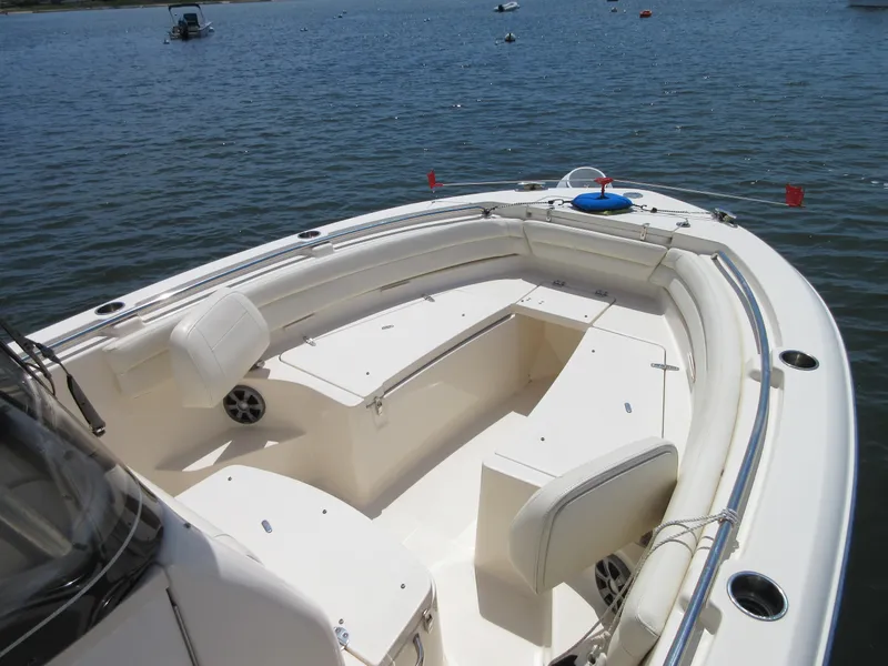 Slide: The Image of 2019 Grady-White Fisherman 236 boat interior with seating and storage, on calm water. - 22