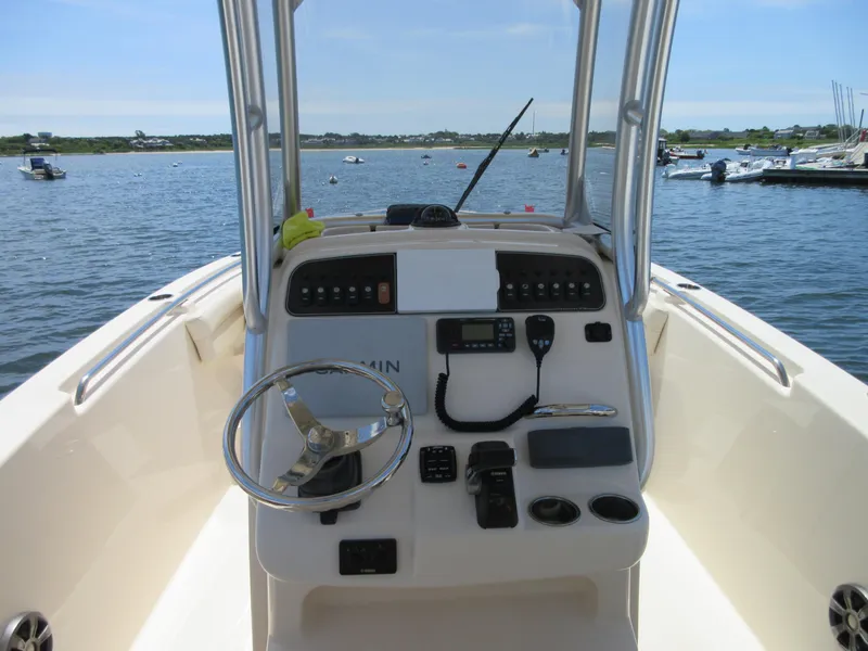 Slide: The Image of 2019 Grady-White Fisherman 236 boat console with steering wheel and controls on open water. - 29