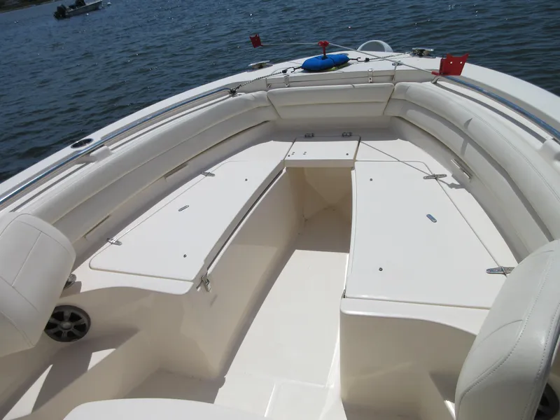 Slide: The Image of 2019 Grady-White Fisherman 236 boat interior with spacious seating and storage, on calm water. - 38
