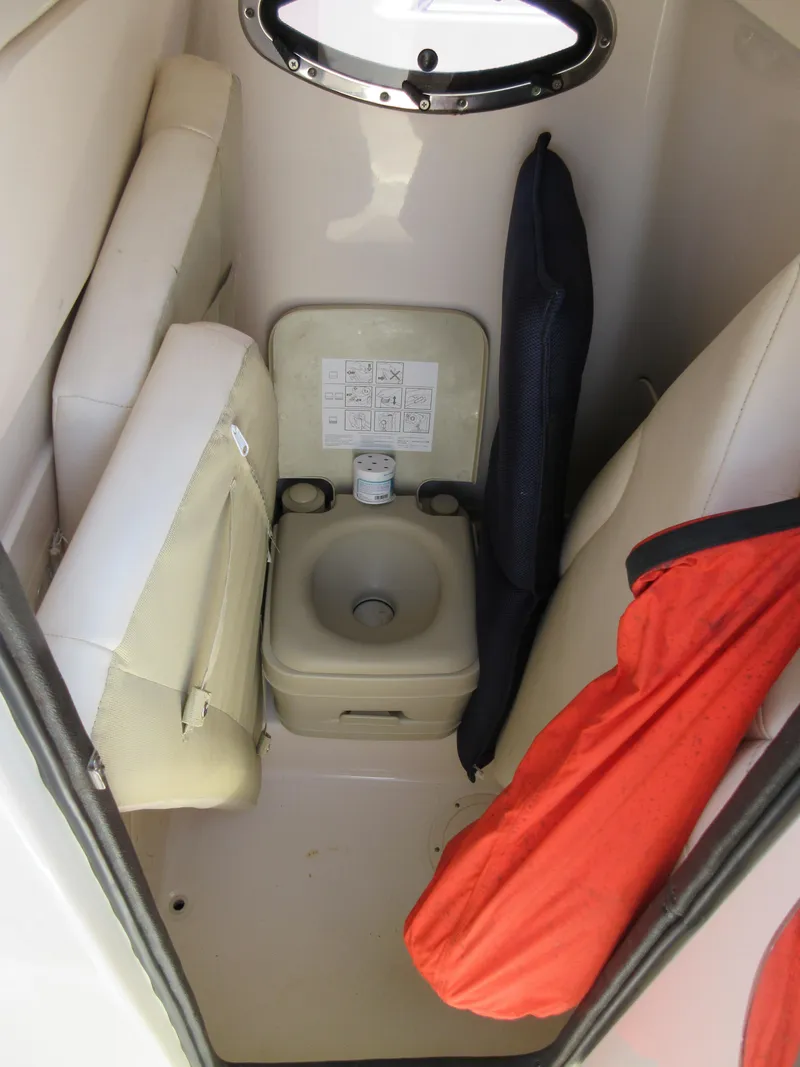 Slide: The Image of 2019 Grady-White Fisherman 236 boat interior with compact marine toilet and storage. - 39