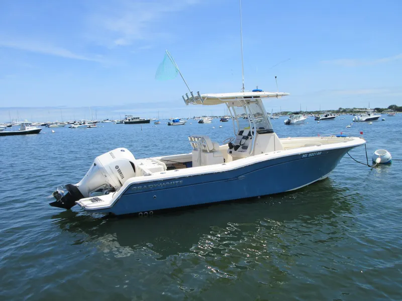 Slide: The Image of 2019 Grady-White Fisherman 236 boat on calm water, surrounded by other boats. - 6