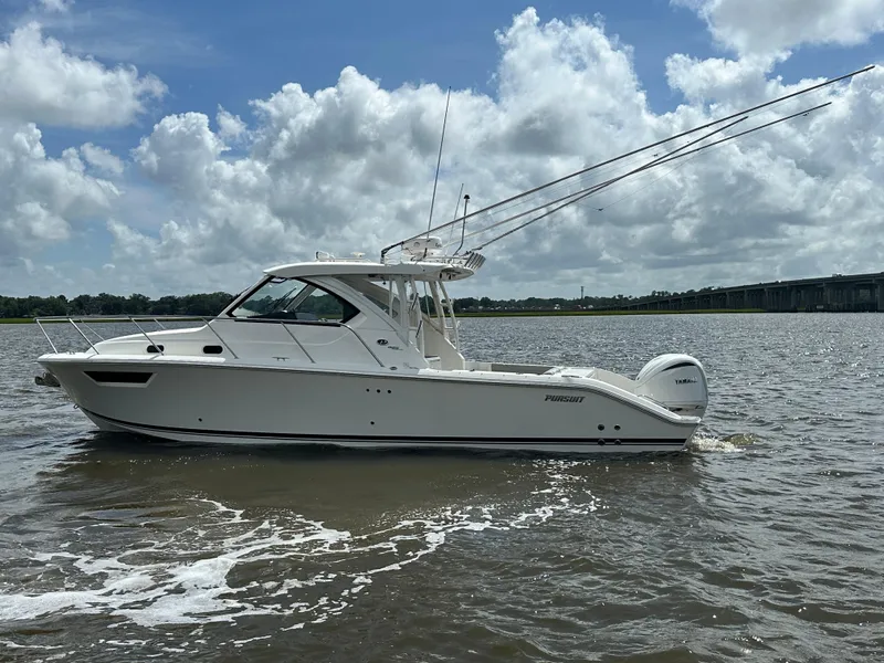 The Image of 2023 Pursuit OS 325 Offshore boat on water under cloudy sky. - 0