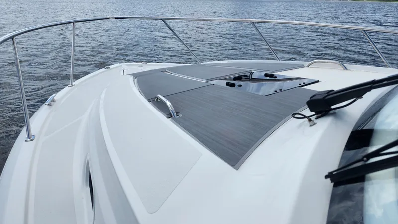Slide: The Image of 2023 Pursuit OS 325 Offshore boat deck on water, showcasing sleek design and modern features. - 12