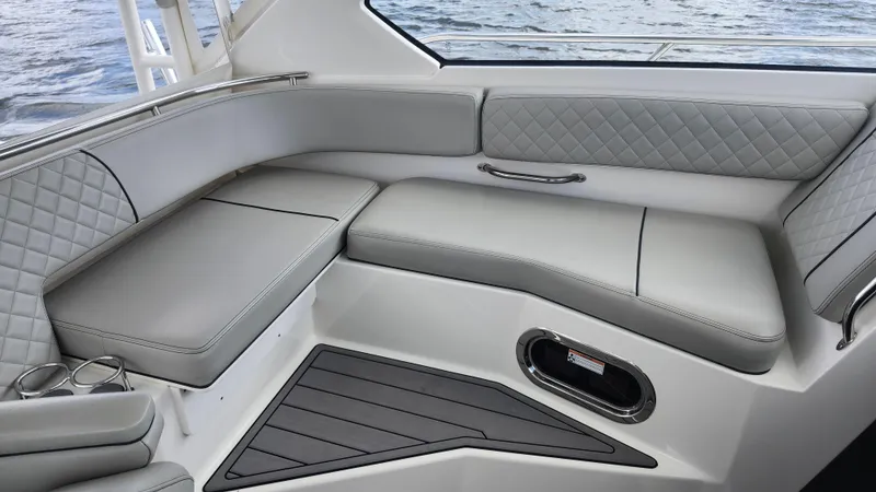 Slide: The Image of Luxurious seating on 2023 Pursuit OS 325 Offshore boat, featuring quilted upholstery and sleek design. - 13