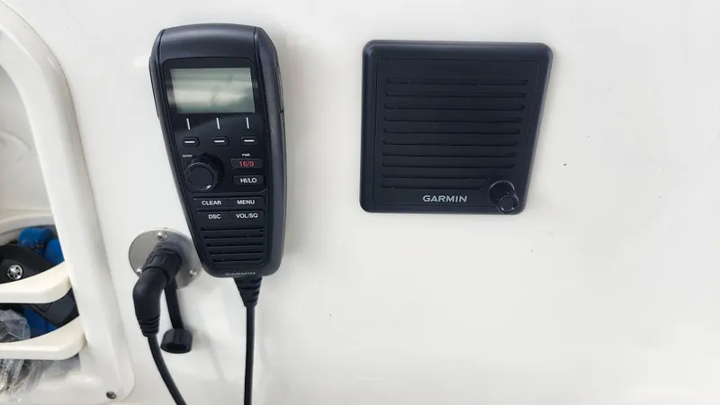 Slide: The Image of Garmin marine radio and speaker on 2023 Pursuit OS 325 Offshore boat. - 18