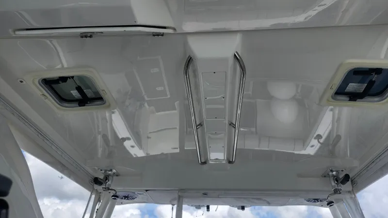 Slide: The Image of 2023 Pursuit OS 325 Offshore boat ceiling with hatches and stainless steel handles. - 19