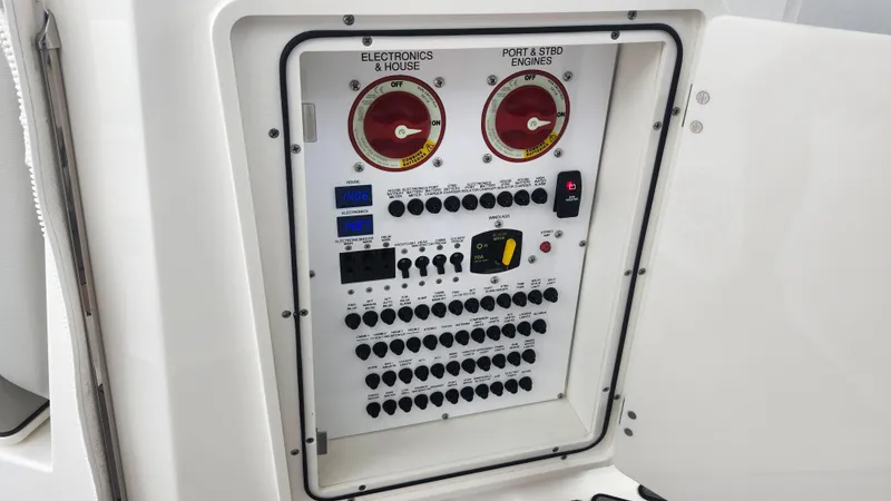 Slide: The Image of Electrical control panel on 2023 Pursuit OS 325 Offshore boat, featuring switches and gauges. - 20
