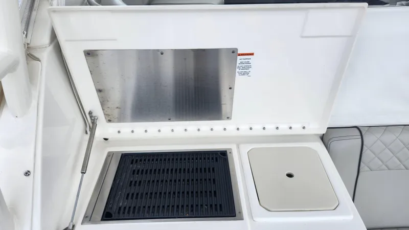 Slide: The Image of 2023 Pursuit OS 325 Offshore boat grill and sink area. - 21