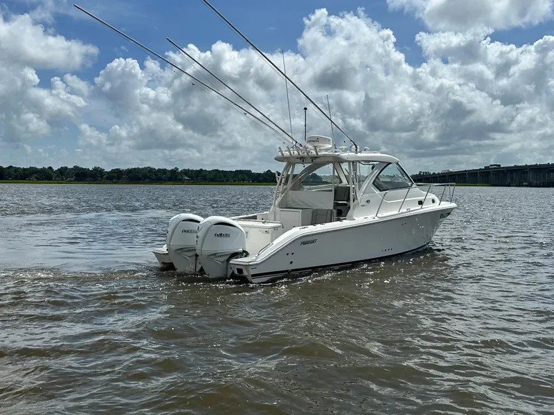 Slide: The Image of 2023 Pursuit OS 325 Offshore boat on water under cloudy sky. - 3