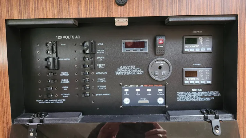 Slide: The Image of Electrical control panel of 2023 Pursuit OS 325 Offshore boat, featuring various switches and displays. - 30
