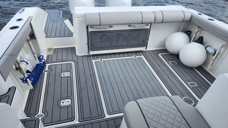 Slide: The Image of 2023 Pursuit OS 325 Offshore boat deck with cushioned seating and storage compartments. - 40