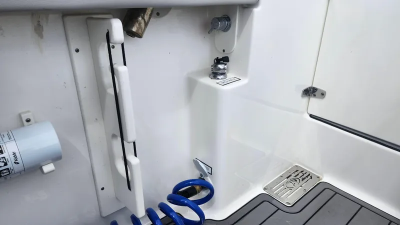 Slide: The Image of 2023 Pursuit OS 325 Offshore boat deck with hose and fittings. - 42