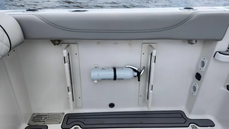Slide: The Image of 2023 Pursuit OS 325 Offshore boat interior with mounted fire extinguisher. - 44