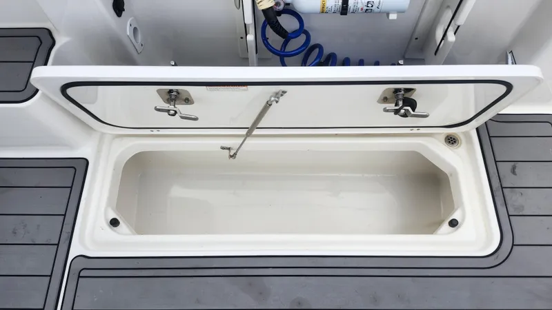 Slide: The Image of Open storage compartment on 2023 Pursuit OS 325 Offshore boat deck. - 45