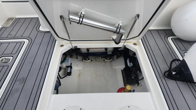 Slide: The Image of Open hatch of 2023 Pursuit OS 325 Offshore boat, revealing storage and equipment. - 46
