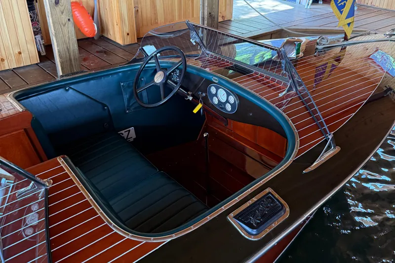 Slide: The Image of 1997 Hacker-Craft 26' Runabout with wooden interior and classic steering wheel. - 11