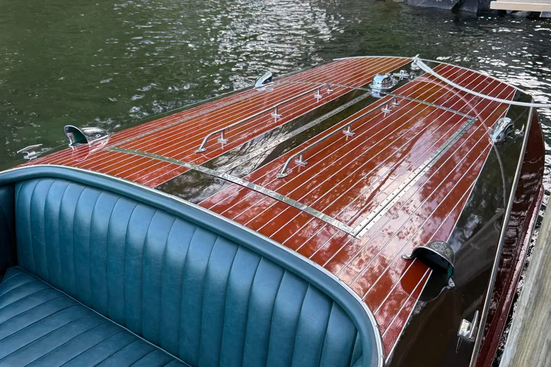 Slide: The Image of 1997 Hacker-Craft 26' Runabout with polished wood finish and blue leather seating. - 19