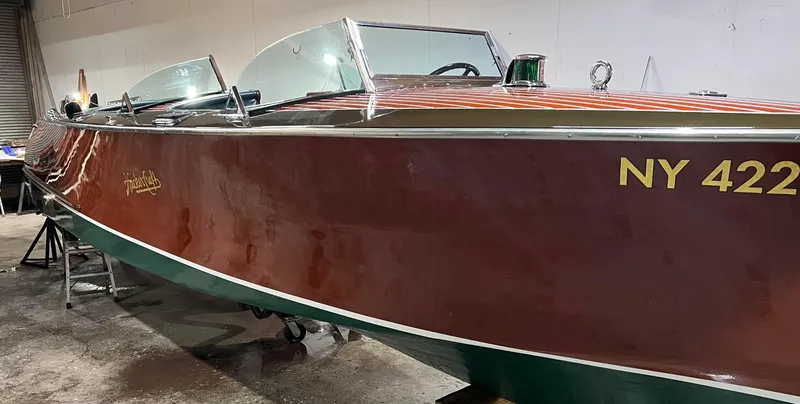 Slide: The Image of 1997 Hacker-Craft 26' Runabout boat with NY 422 registration in a garage setting. - 2