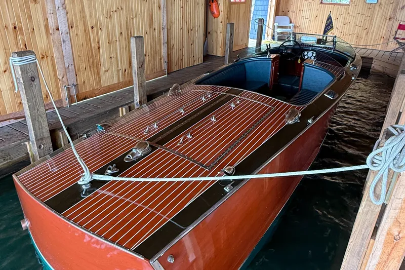 Slide: The Image of 1997 Hacker-Craft 26' Runabout in wooden boathouse, showcasing classic design and craftsmanship. - 20