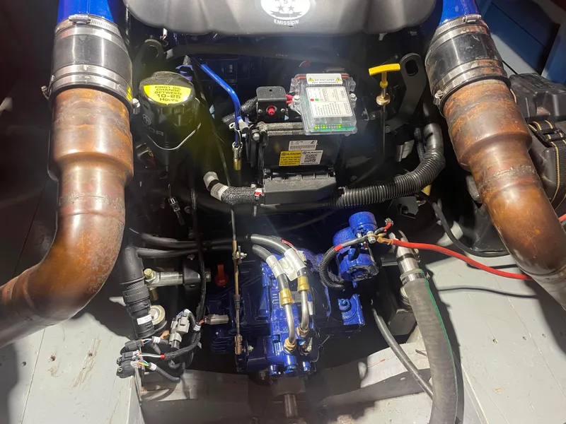 Slide: The Image of Engine compartment of a 1997 Hacker-Craft 26' Runabout, showcasing mechanical components and wiring. - 24