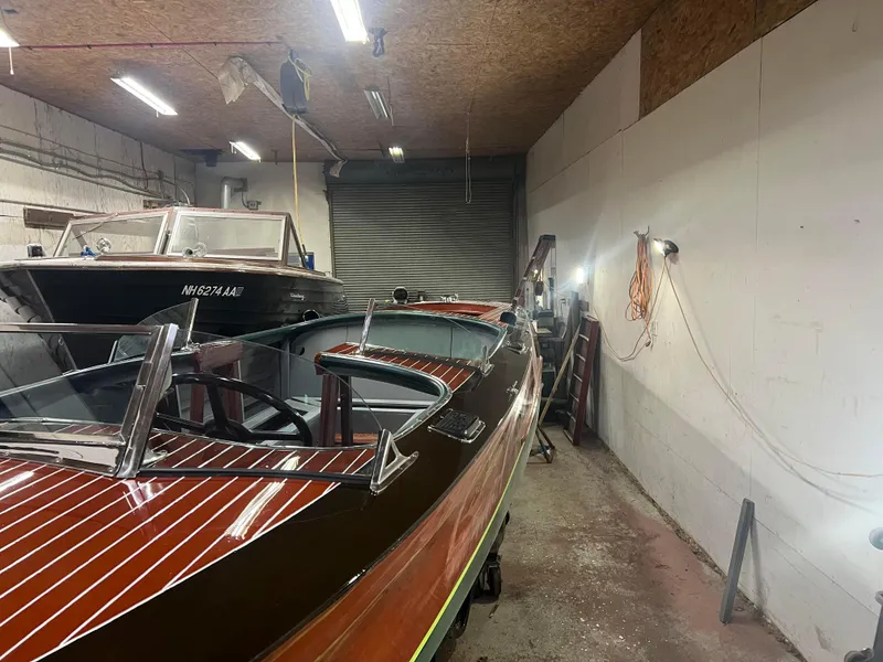 Slide: The Image of 1997 Hacker-Craft 26' Runabout in a workshop, showcasing classic wooden design. - 8