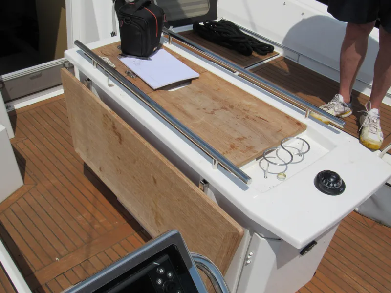 Slide: The Image of Beneteau Oceanis 46.1 cockpit with wooden table, compass, and equipment, 2020 model. - 22