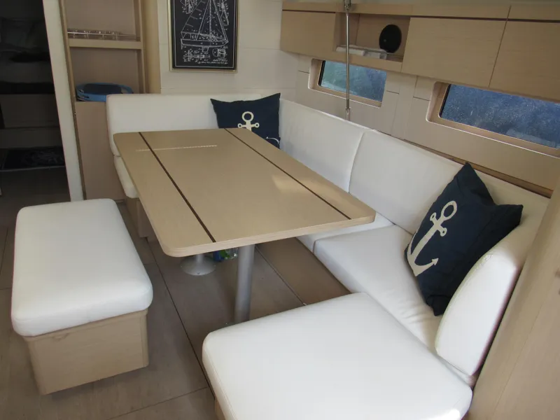 Slide: The Image of Interior of 2020 Beneteau Oceanis 46.1 yacht with white seating and nautical decor. - 5