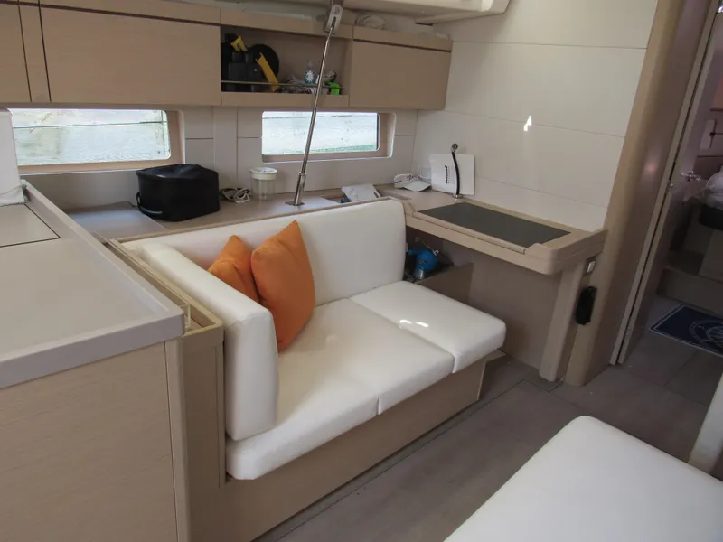 Slide: The Image of Interior of 2020 Beneteau Oceanis 46.1 yacht with modern seating and light wood finishes. - 7