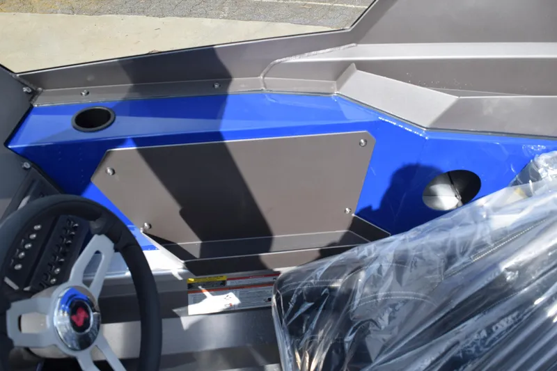 Slide: The Image of Interior view of 2026 Stabicraft 2050 Treker Profish boat, featuring steering wheel and blue panel. - 15