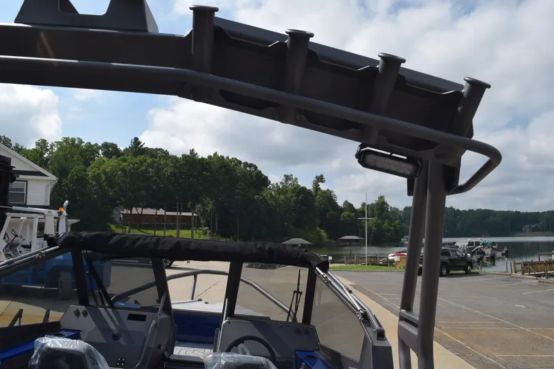 Slide: The Image of Stabicraft 2050 Treker Profish 2026 at a lakeside dock, surrounded by trees and boats. - 24