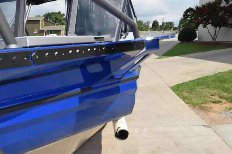 Slide: The Image of 2026 Stabicraft 2050 Treker Profish boat, blue exterior, parked on a driveway. - 5