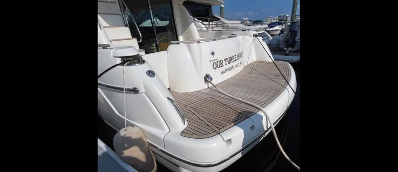 Slide: The Image of Jeanneau Prestige 46 yacht, 2007 model, docked with teak deck and visible nameplate. - 2