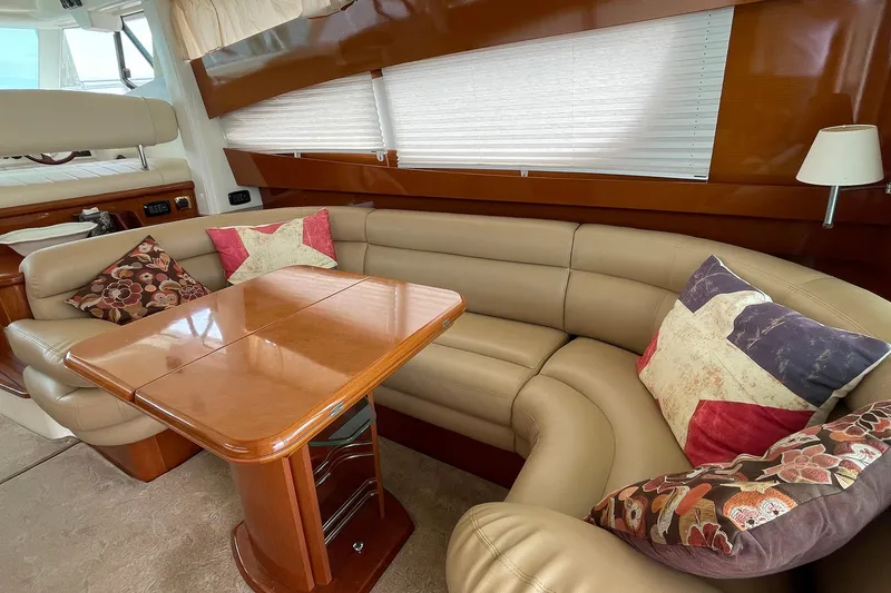 Slide: The Image of Luxurious interior of 2007 Jeanneau Prestige 46 yacht with leather seating and wooden table. - 6